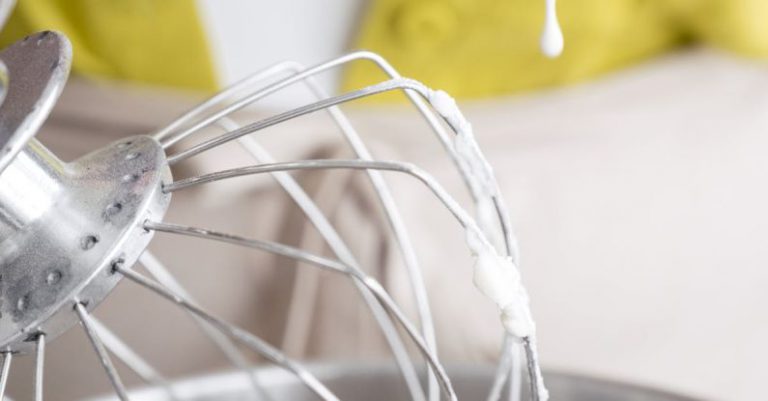 Stand Mixer - Crop unrecognizable female confectioner pouring melted sugar syrup into planetary mixer with whipped egg whites