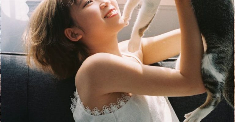 Pet-friendly Home - Smiling Girl Playing with Cat