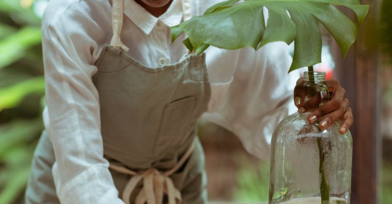 Green Appliances - Focused housewife in apron cleaning wooden table