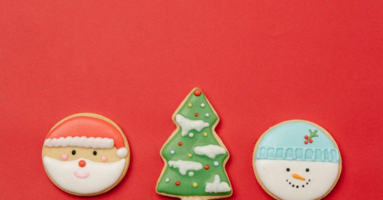 Kitchen Layout - From above composition of traditional Christmas gingerbread cookies decorated with icing in red background