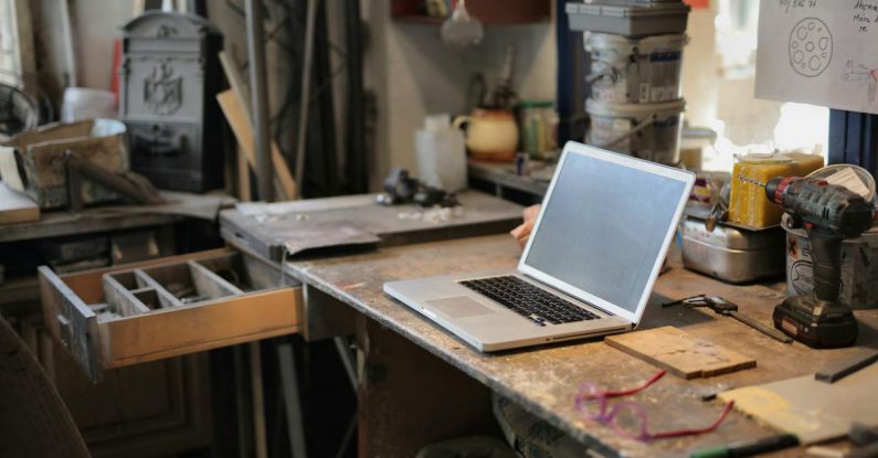 Workshop Organization - From above of modern laptop laying at table among different tools and equipment in workshop