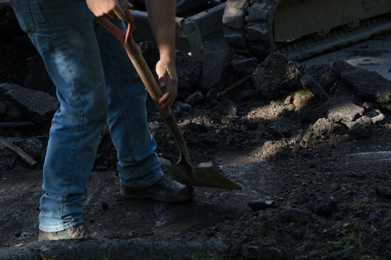 Hardscaping - person holding brown wooden shovel