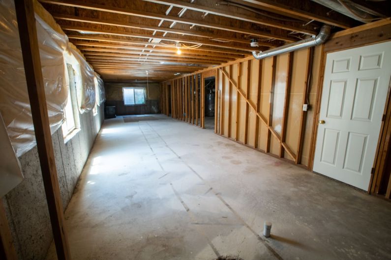 Basement - brown wooden door near white wall