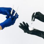 Close-up of gloved hands using beauty tools, focusing on careful application.