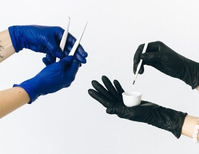Close-up of gloved hands using beauty tools, focusing on careful application.